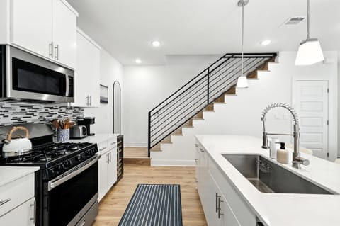 fully stocked kitchen has oven, microwave, beverage center, coffee.