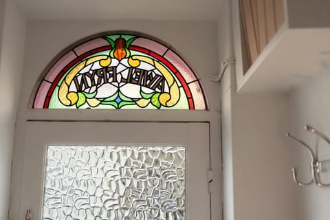 Front door fan light with cottage name in stained glass