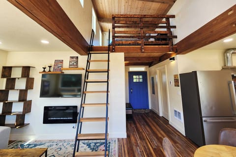 Ladder up to the bedroom in the loft. Electric fireplace and tv for your enjoyment.