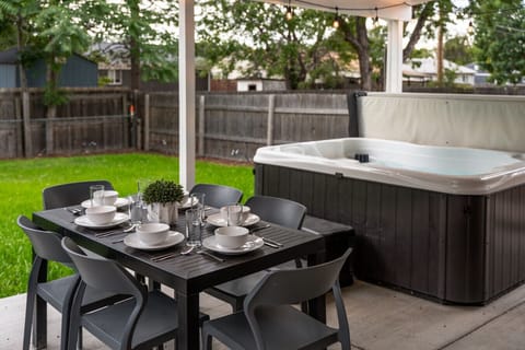 Huge backyard with covered patio, hot tub, fire pit, yard games, and plenty of seating for everyone!