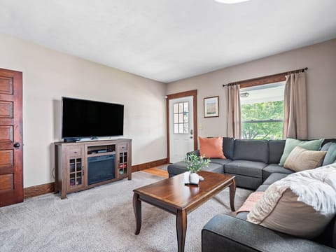 Cozy living room with comfy sectional sofa, smart TV & natural light 🌿🛋️✨