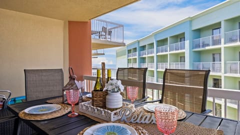 Private balcony with outdoor dining and views of the Gulf Coast.