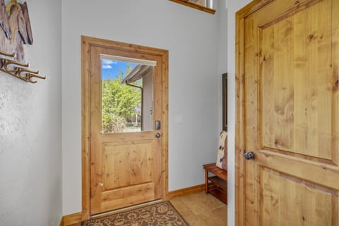 Front door entry and adjacent downstairs powder room is one of 3.5 bathrooms in this home.