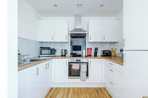 Sleek, functional space with oven, hob, fridge, and all cooking essentials.