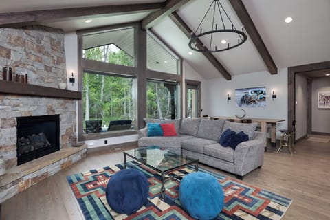 living space with fireplace and windows facing the Viking Creek Wetland Preserve