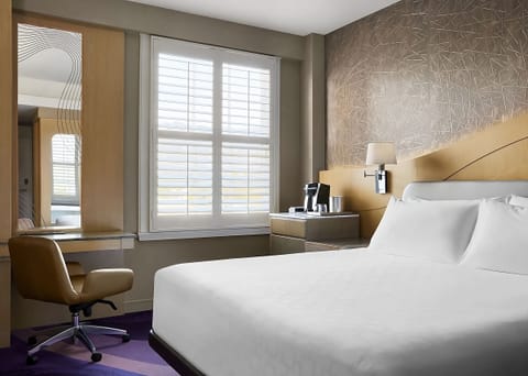 Unwind in crisp linens beside bright, peaceful window light.