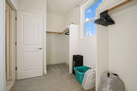 Large walk in closet with pack n play and an air mattress.