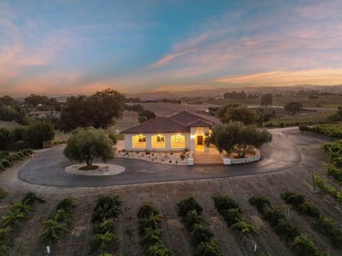 Stunning twilight exterior of the home with vineyard view.