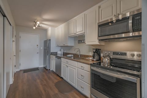 The sleek full kitchen is equipped with modern appliances, providing everything you need for cooking and dining.