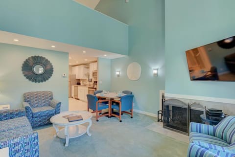Step into the airy living space of this 2 Queen Bedroom Loft, featuring vibrant decor and a cozy dining area perfect for family gatherings.