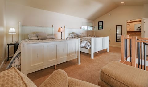 Relax in the charming loft bedroom, which is elegantly furnished with two queen beds, ensuring comfortable accommodation for all guests.