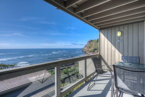 Enjoy breathtaking panoramic ocean views from the private balcony, where comfortable seating invites you to relax and soak in the beauty of the coastline.