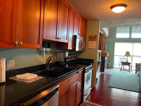 This well-equipped full kitchen boasts sleek cabinetry, modern appliances, and ample counter space, perfect for preparing delicious meals.