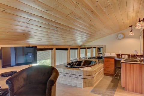 In the king bedroom, enjoy luxury and relaxation with a private jacuzzi tub, all set against a backdrop of stunning ocean views.