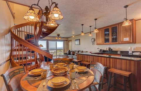 The dining area is inviting and perfect for family meals, featuring an elegant table set for gatherings and beautiful views of the ocean.