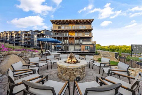 Enjoy cozy evenings around the fire pit with 12 cushioned lounge chairs. This inviting outdoor space offers beautiful views and the perfect setting for relaxing, socializing, and making unforgettable memories with friends and family under the open sky.