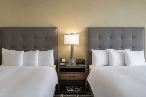 Drift off on cloud-soft linens under warm bedside glow.