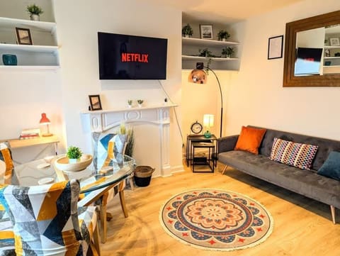 This multi-functional living area combines relaxation and productivity with a Smart TV, study desk, stylish lamps, and an adjoining dining area for casual meals or gatherings.