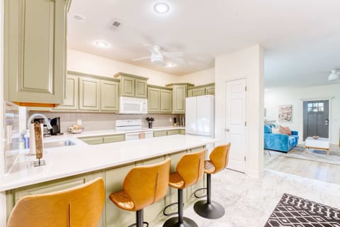 A harmonious blend of form and feeling. This inviting kitchen features an expansive island, perfect for casual dining or entertaining.