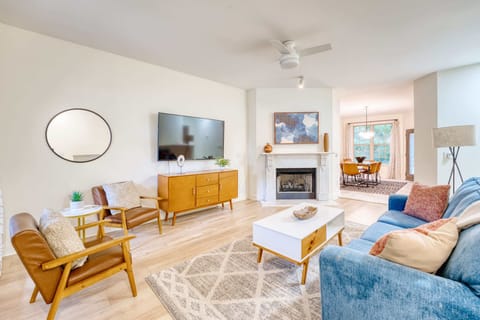 Bright, mid‑century living room with smart TV & cozy fireplace—perfect for relaxing after a day on the trails.