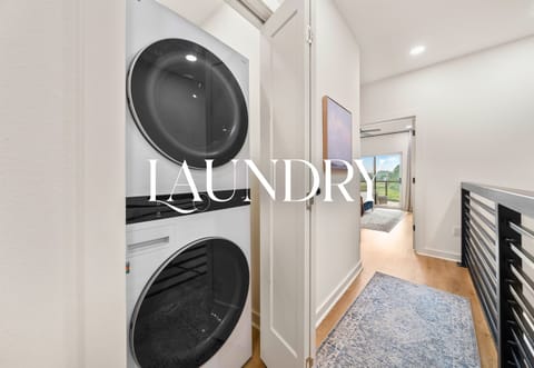 Laundry room with washer and dryer for guest convenience.