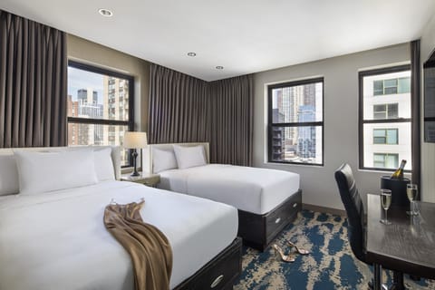 Unwind in bright twin beds with sweeping city views.
