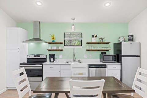 Full kitchen with stainless steel appliances.