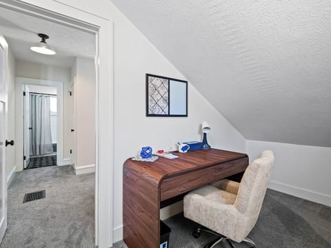 Simple hallway corner w/ a tidy desk—perfect for a quick workspace.