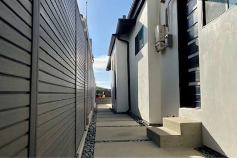 Entrance to the three story home and the outdoor shower with hot and cold H2O.