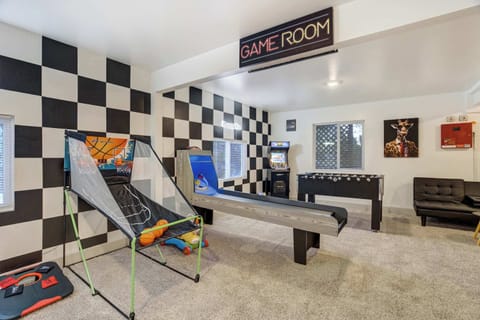 Step into the vibrant shared game room featuring basketball shootout, skee-ball, foosball, and retro arcade machines — the perfect hangout spot for friendly competition.