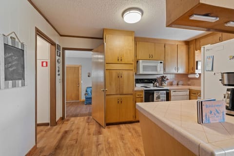Fully equipped kitchen with plenty of pots, pans, utensils and essentials for preparing meals at home