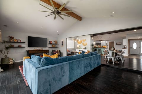 Living room 1 with ceiling fan, TV, large windows