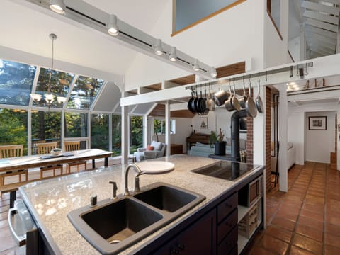 Updated kitchen with expansive tree views and open concept to living space