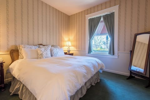 Unwind in a cozy bedroom with soft linens and sunshine.