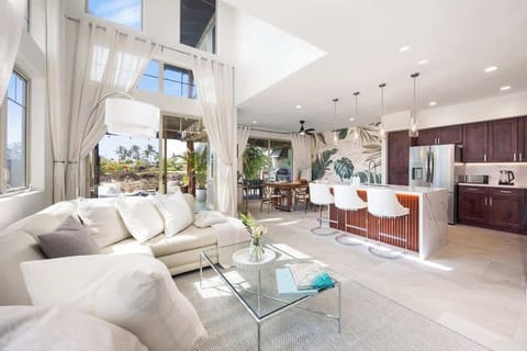 Spacious living room with modern kitchen and bar seating