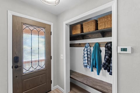 Entryway with coat hooks and storage.