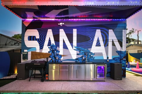 Outdoor kitchen with smoker, sink and mini fridge