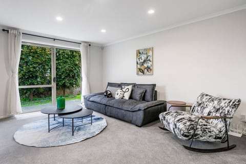 This living room is part of the open-plan space including the kitchen and dining space.