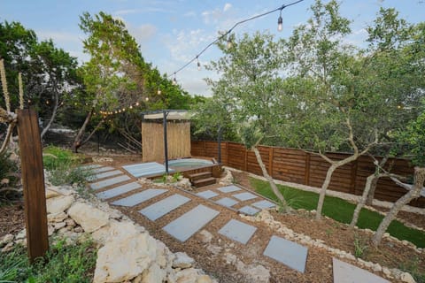 The backyard offers a balance of comfort and style with its pool, string lights, and landscaped touches that make outdoor time enjoyable.