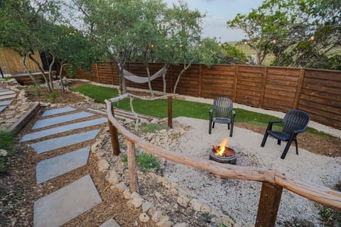 A hammock for daytime lounging and a fire pit for nighttime conversations create a backyard that’s welcoming any time of day.