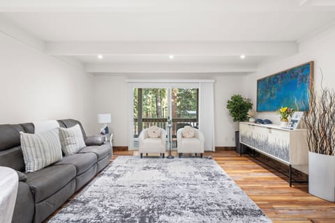 Living room with cozy seating, charming decor, and seamless access to the balcony.