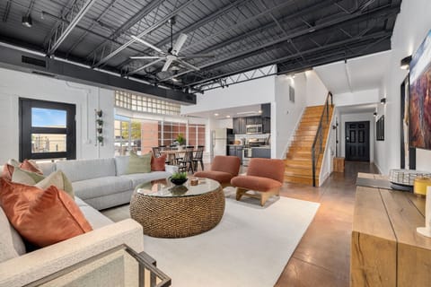 Open-concept living room flowing into the kitchen and dining area.