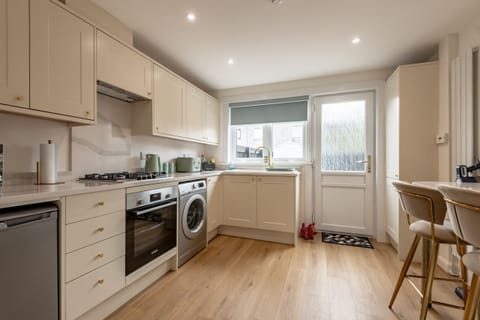 Contemporary Fitted Kitchen with Warm Wooden Flooring