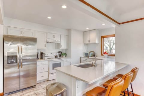 Bright and Tidy White Kitchen with Everything Needed for Cooking and Dining