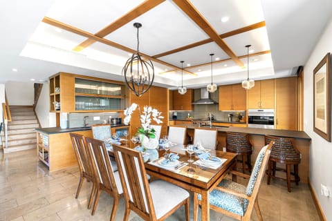 The open-concept kitchen and dining space is perfect for gathering and group meals at Laule'a #14.