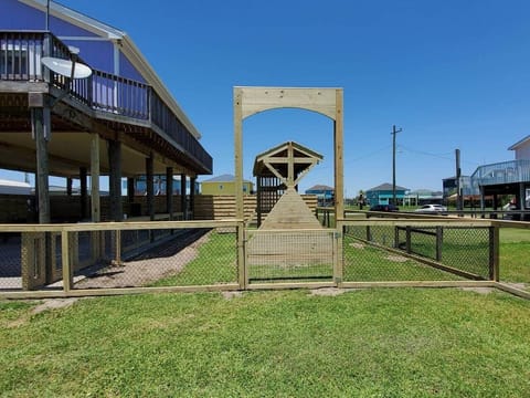 Fenced in yard with playground