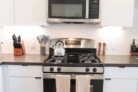 Experience extended comfort with a fully equipped kitchen featuring a coffee machine, stovetop, and microwaveâeverything you need for a seamless long-term stay