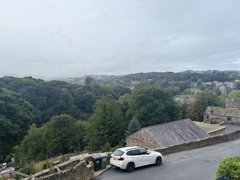 Please park where the white car is parked.