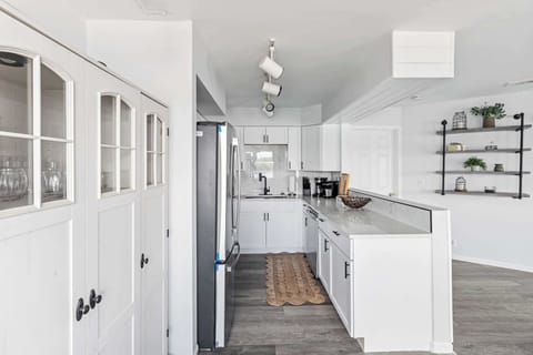 Fully stocked kitchen with rich wood cabinetry, modern appliances, and plenty of counter space