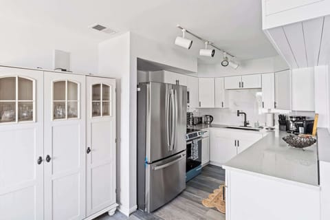 Fully stocked kitchen with rich wood cabinetry, modern appliances, and plenty of counter space